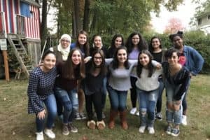 A group of Muslim and Jewish teenagers pose together for a group photo 