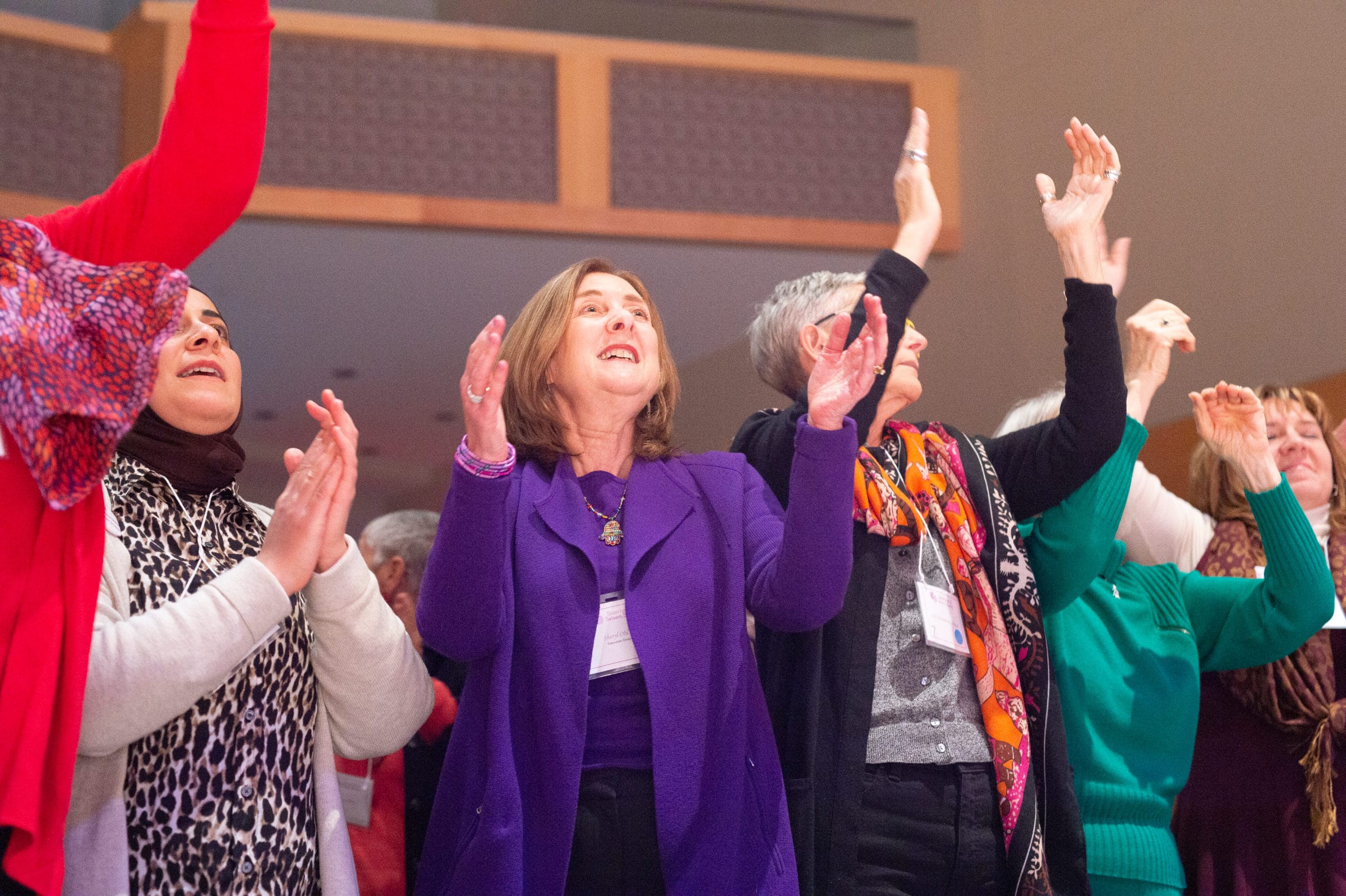 women clapping in song