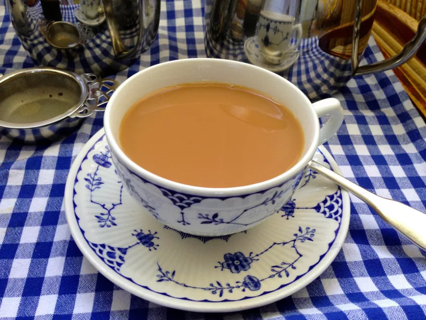 cup of tea on a blue and white checked table cloth